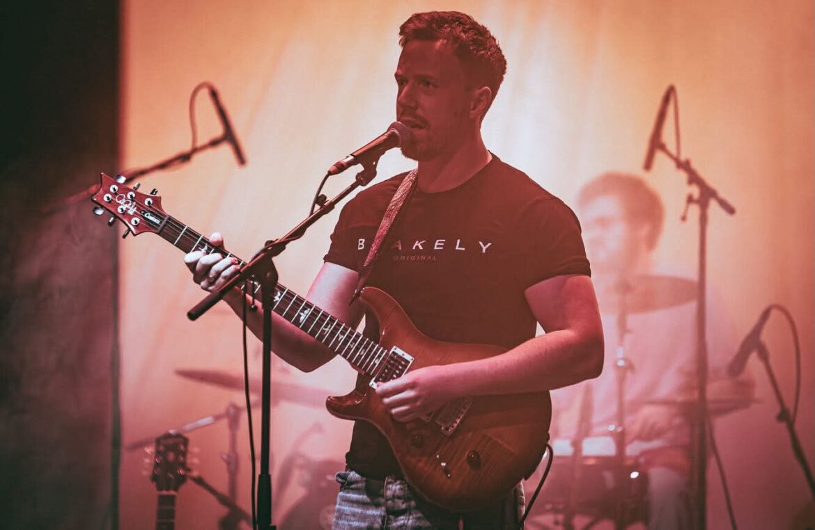 Guitarist of Wandering Orange performing