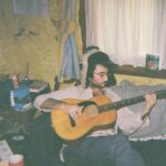 Tom Emlyn with a guitar