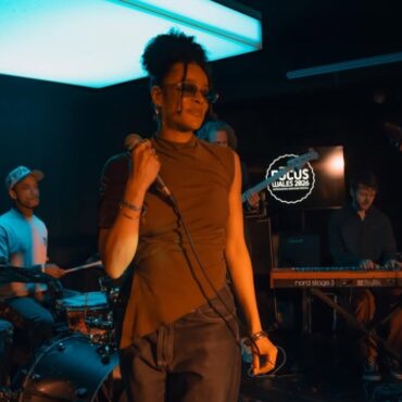 Lily Webbe holding a microphone on a stage