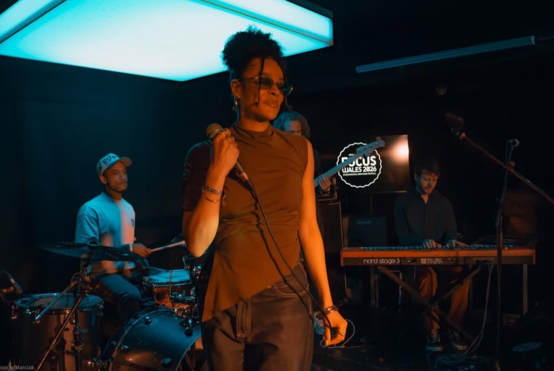 Lily Webbe holding a microphone on a stage