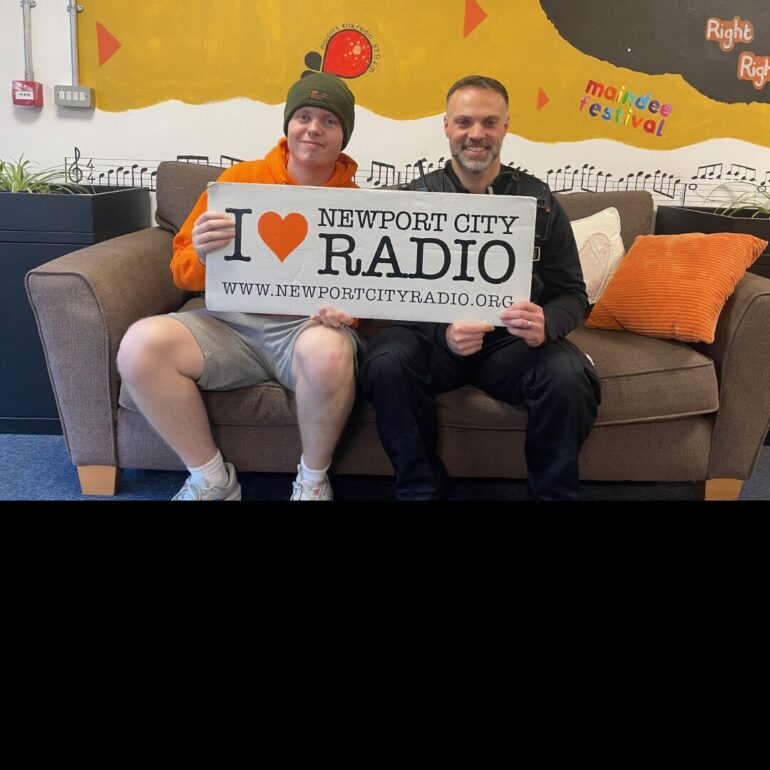 Luke sat on sofa with Sergeant Jason Ghalamkary